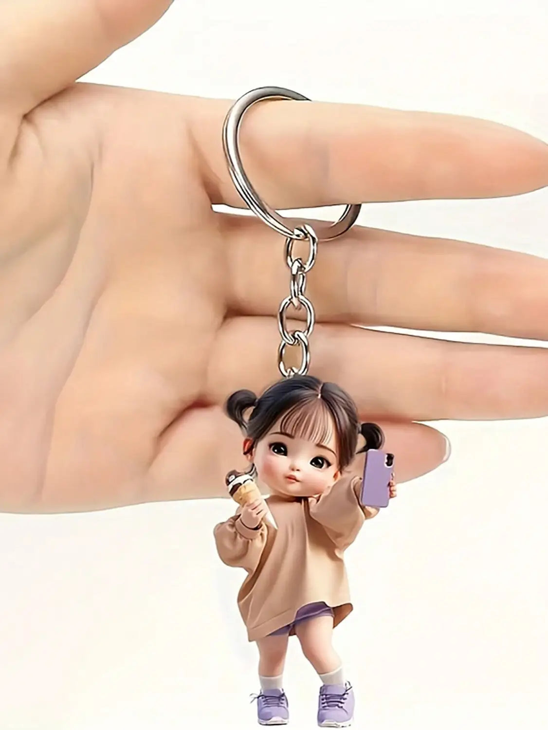 A cute acrylic girl keychain cartoon pendant featuring a detailed figurine of a young girl with dark pigtails, wearing a beige sweater and purple shoes, holding an ice cream cone and a small phone.