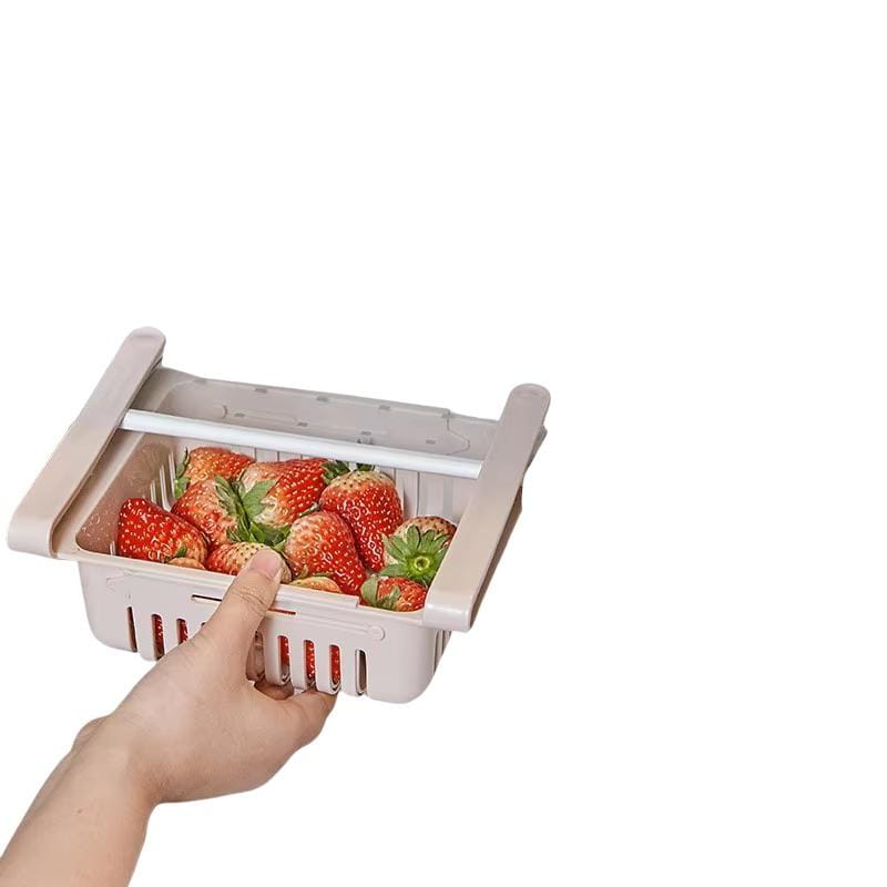 Beige food-grade polypropylene sink drain rack with slotted design and handle holding fresh red strawberries for adjustable kitchen shelf organization.
