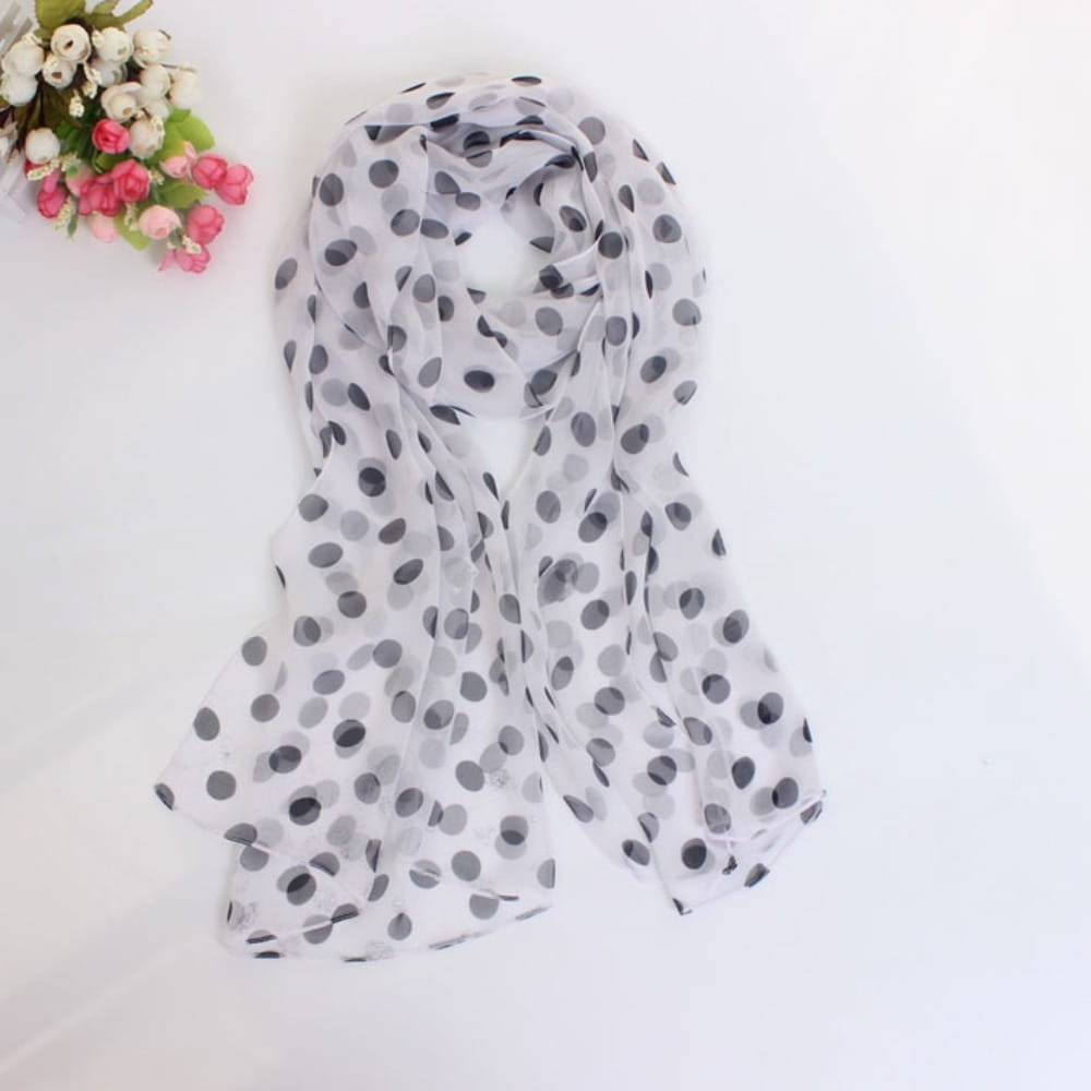 A sheer white polka dot silk head wrap scarf with a pattern of black dots.