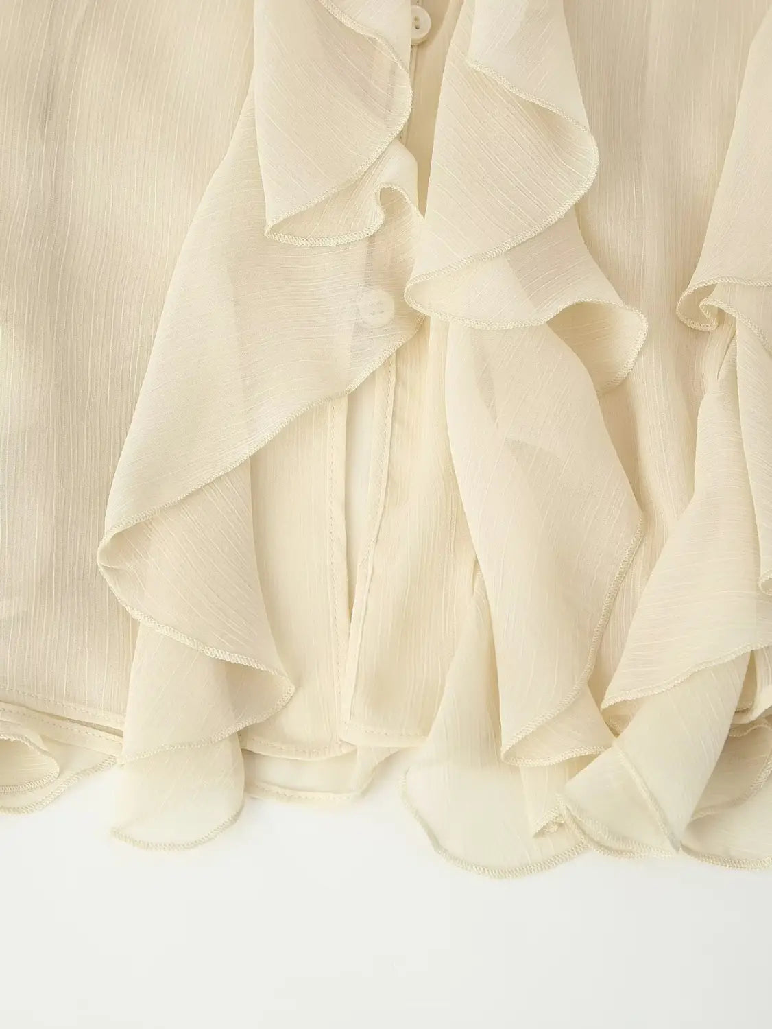 a delicate cream-colored ruffle shirt long sleeve chiffon blouse with layered ruffles and a subtle ribbed texture