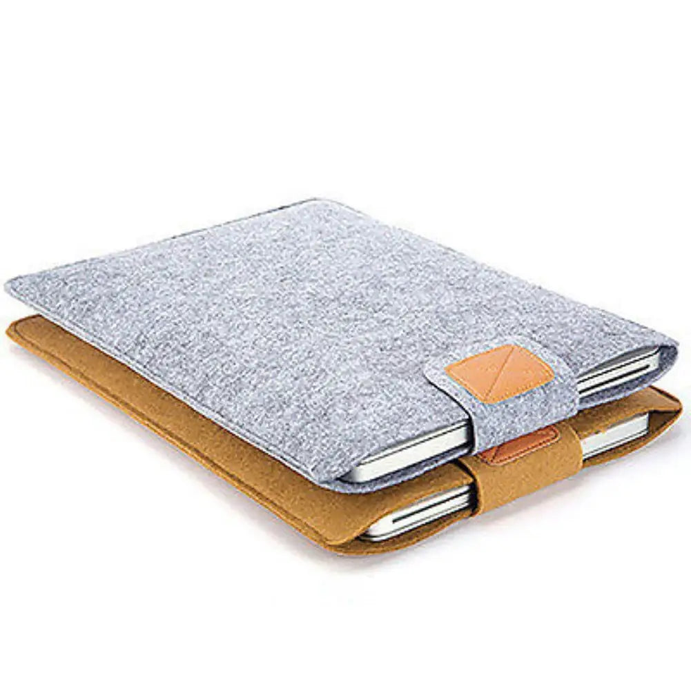 Gray felt laptop bag sleeve for macbook air with tan leather accents and triangular flap closure designed as a protective tablet bag.