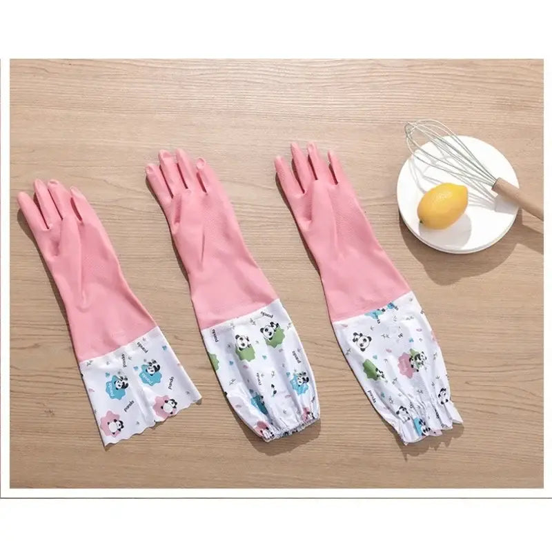 Pink waterproof kitchen gloves made of rubber with a white panda-patterned elastic cuff for cleaning.