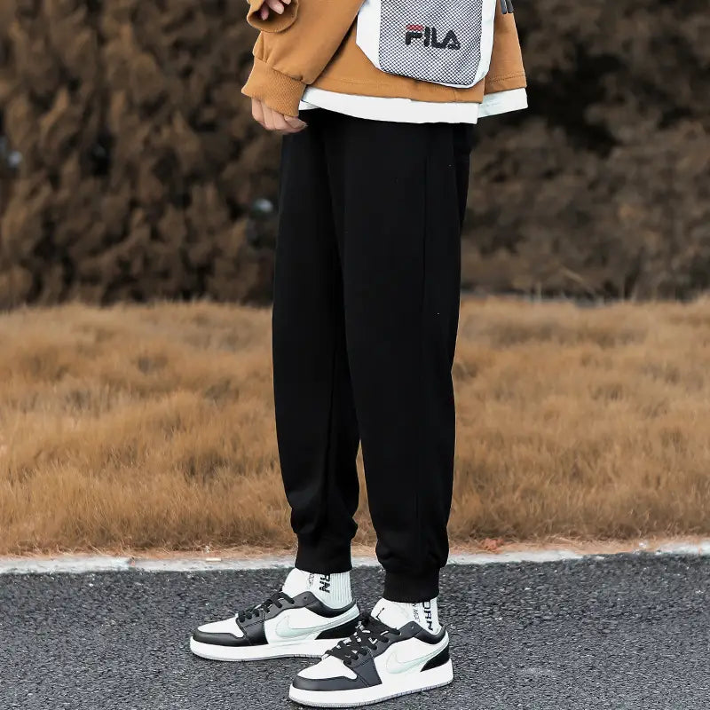 Men cargo pants black tapered jogger pants with ribbed cuffs made of soft stretchy fabric for casual wear.