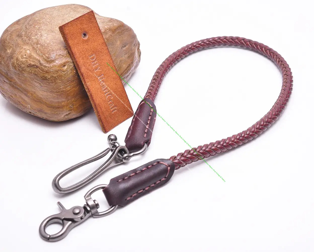 A braided burgundy leather camera strap with dark brown leather end piece and silver-toned metal carabiner clips designed as a leather biker wallet chain punk jeans accessory.