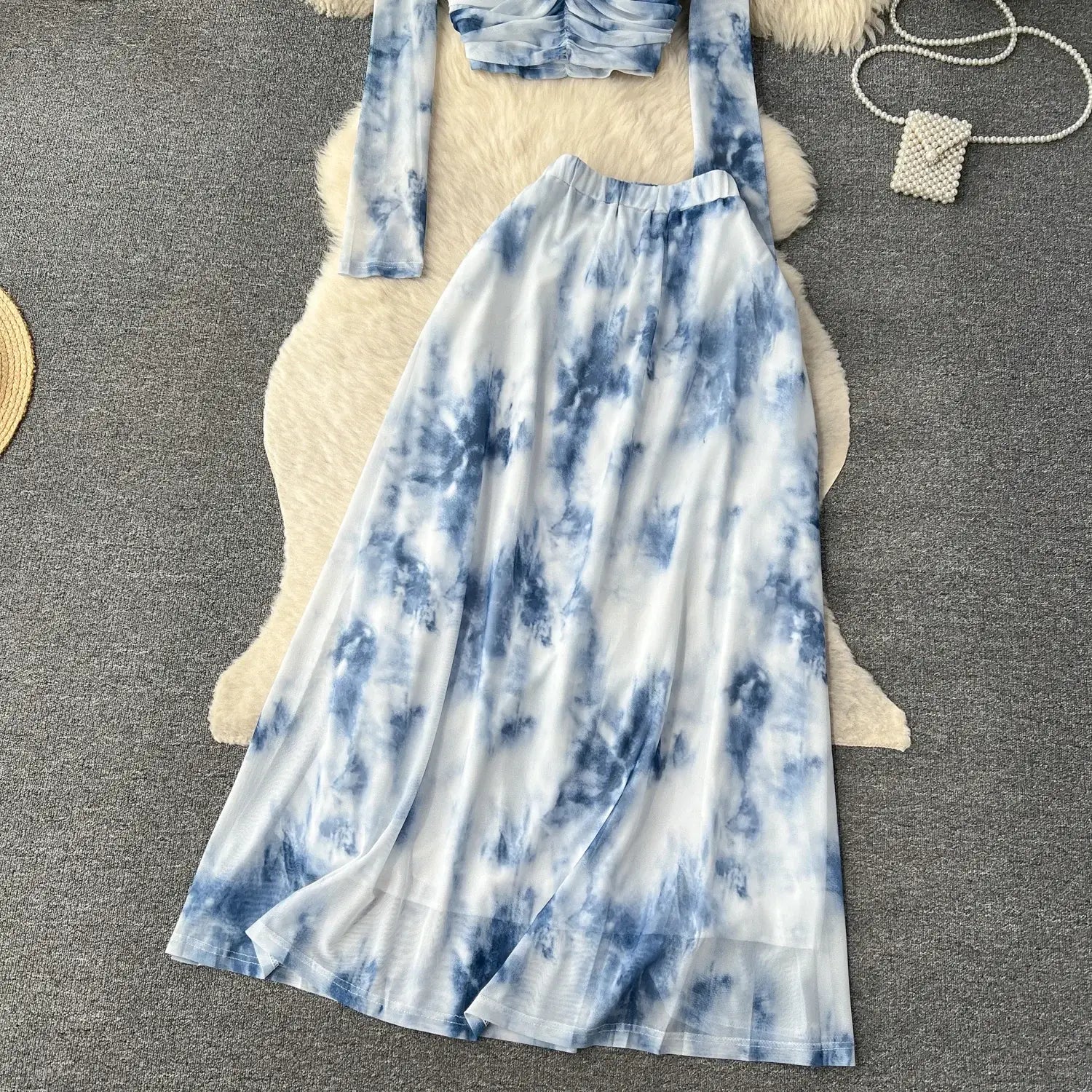 a flowing blue and white tie-dye mesh maxi skirt with a marble print and a high waistband featuring an elastic closure type in the two piece mesh skirt set