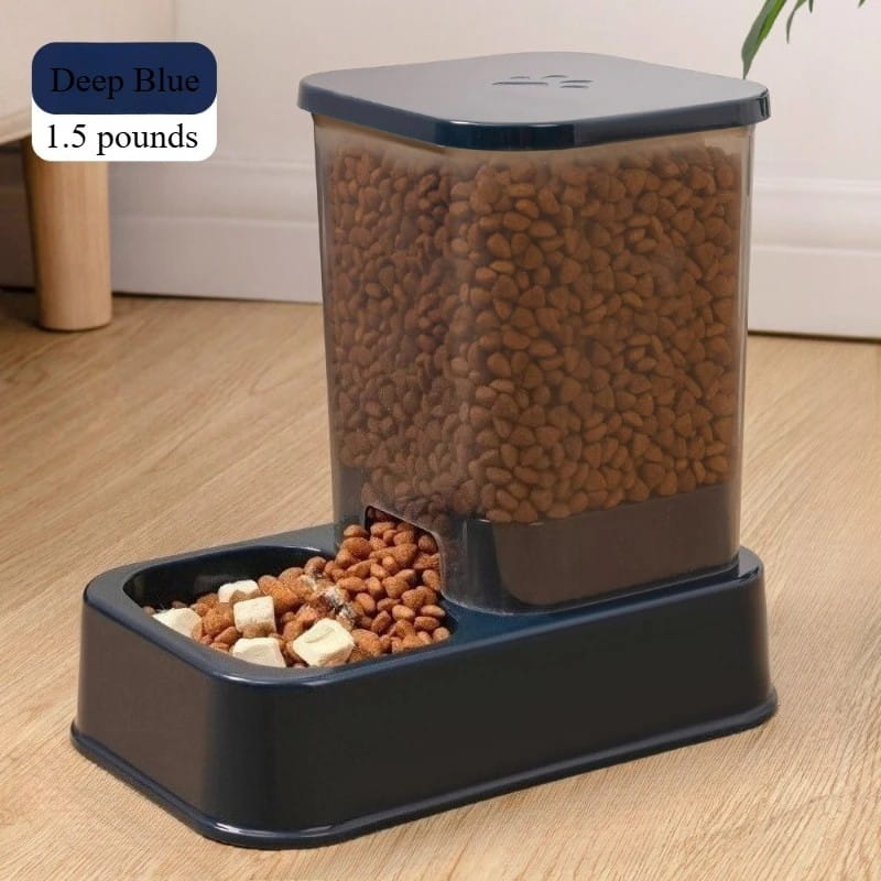 Deep blue plastic automatic pet feeder with clear container and dual feeding compartments designed for precise portion dispensing and water supply.