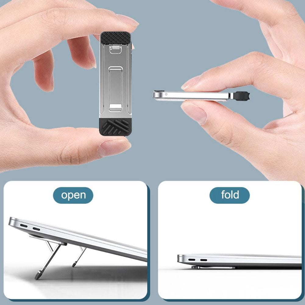 Support portable pour ordinateur portable pliant en aluminium, argent et noir, avec des surfaces de prise texturées pour un positionnement sûr de l’appareil.