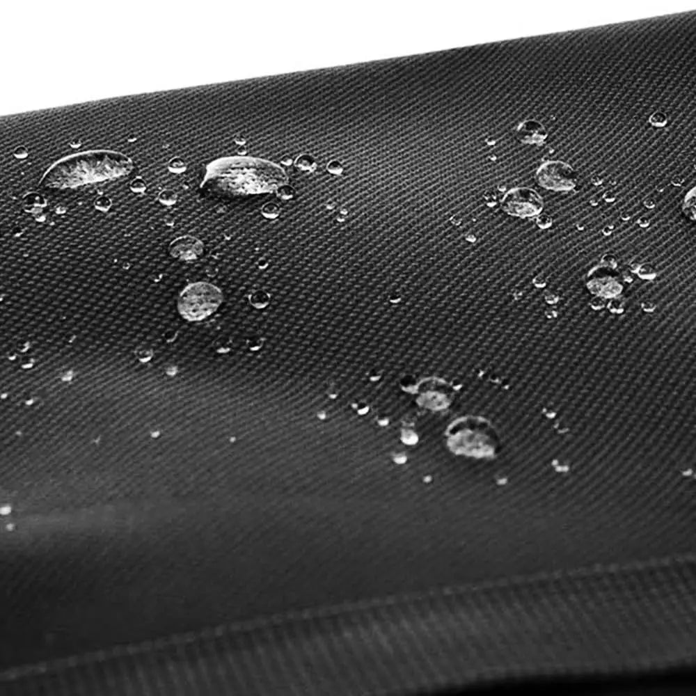 Schwarzer strukturierter Stoff mit an der Oberfläche der Ztz 50l wasserfesten Doppelfahrradtasche auftropfenden Wassertropfen, die das wasserabweisende Material hervorheben.