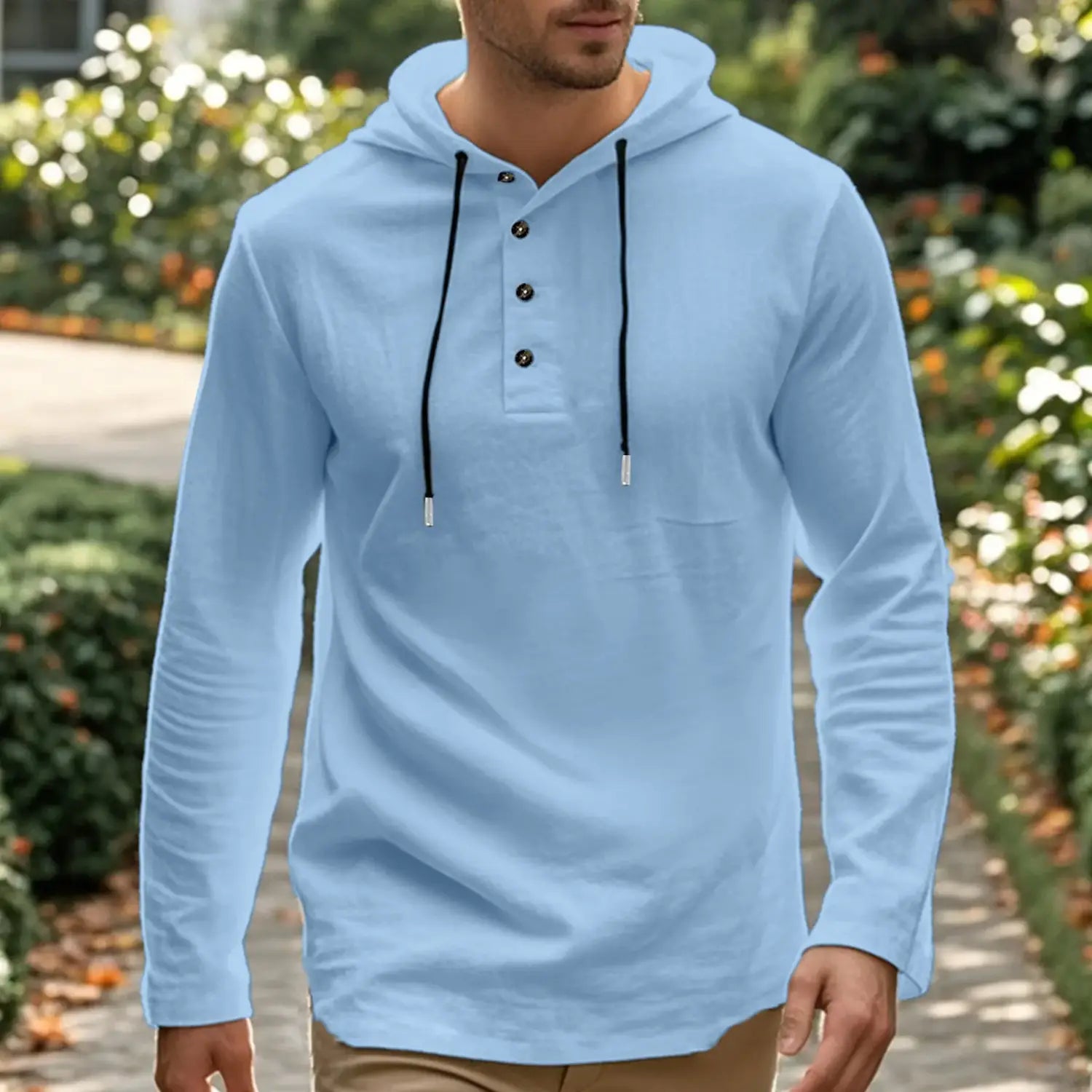 Light blue men cotton linen hooded henley shirt with long sleeves black drawstrings and button details.