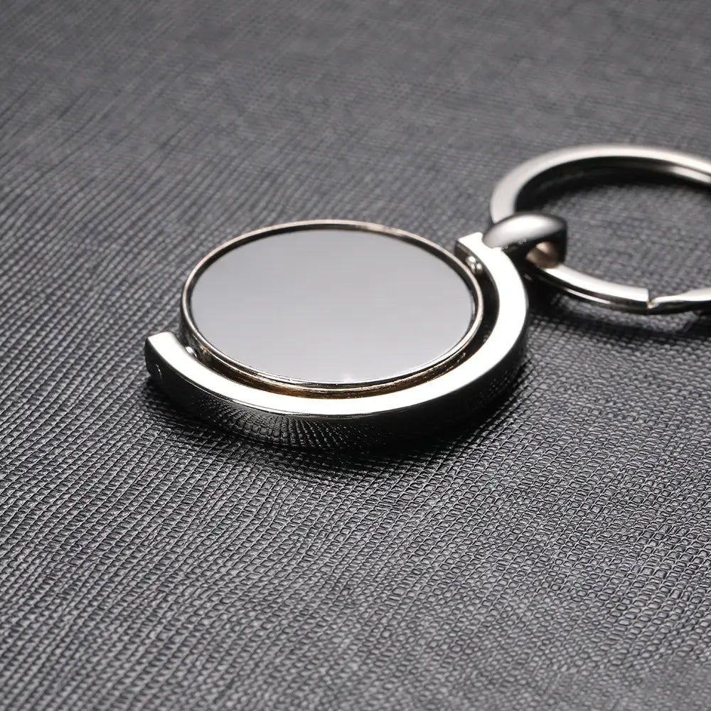 Silver rotating circle keychain gift featuring a spinning circular reflective face and polished metal rings.