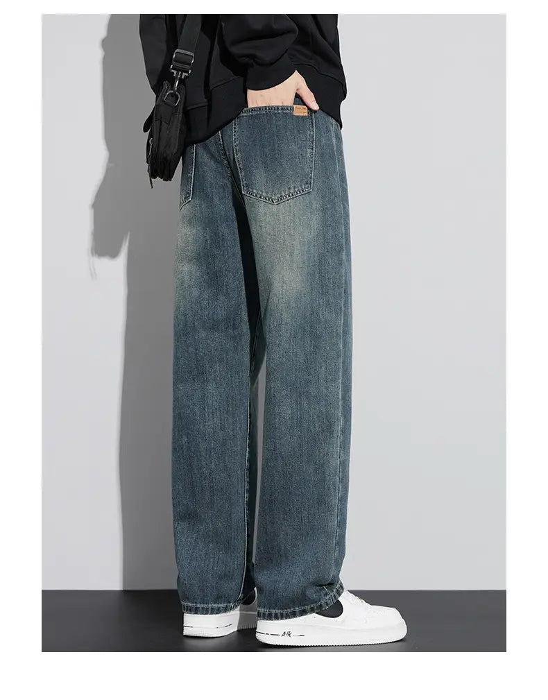 Jeans droits amples doublés de polaire pour homme en denim à lavage foncé, avec une coupe droite décontractée et un délavage subtil pour un look moderne décontracté.