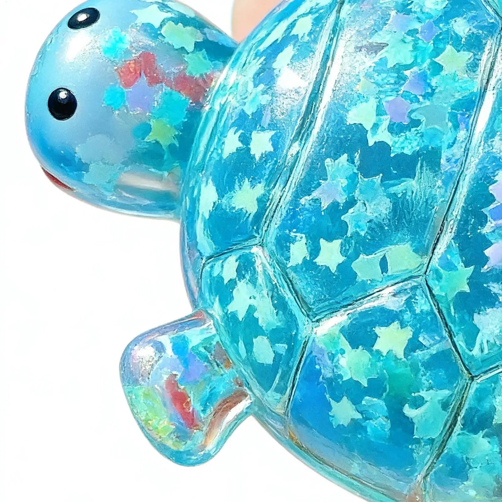 Translucent blue turtle shape squeeze toy with iridescent star glitter embedded for sensory fidget use