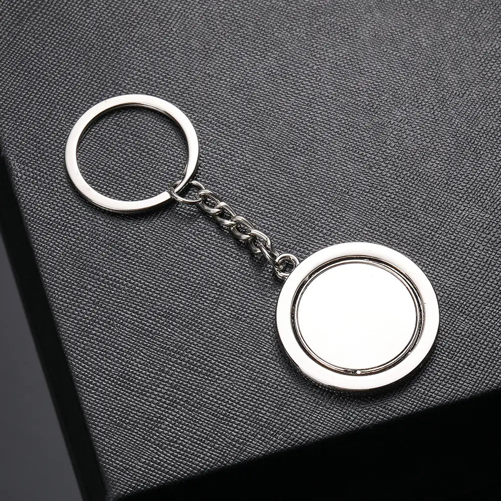Silver metallic rotating circle keychain gift featuring a circular double-ringed pendant and chain.