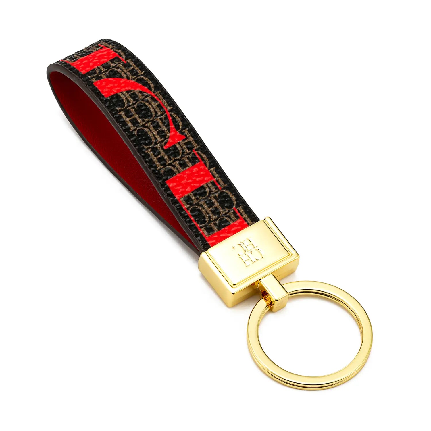Leather logo keychain designer fashion accessory featuring a red and black patterned key fob with gold-tone metal ring and plaque.