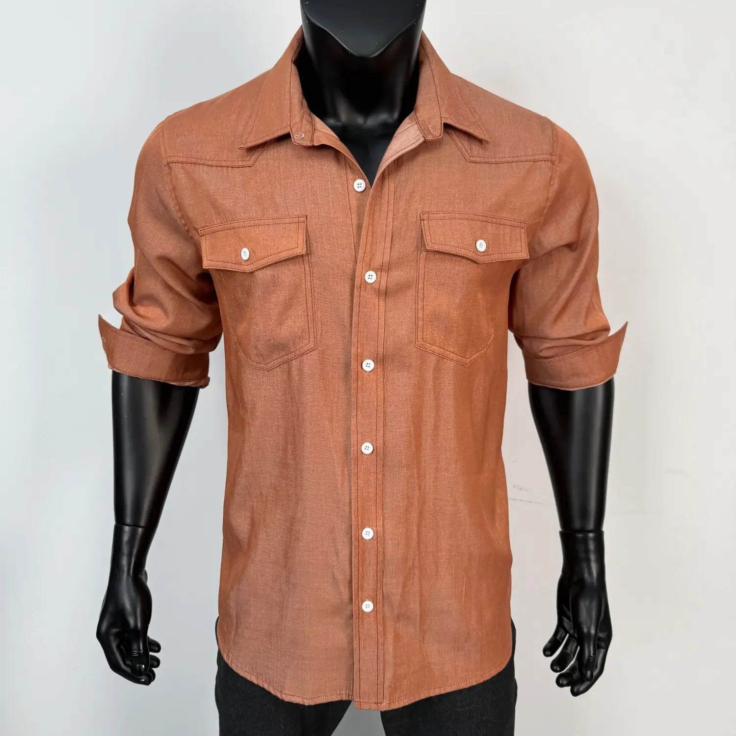 Men’s vintage denim shirt in rust color with button-up front, two chest pockets, and rolled sleeves for casual workwear.