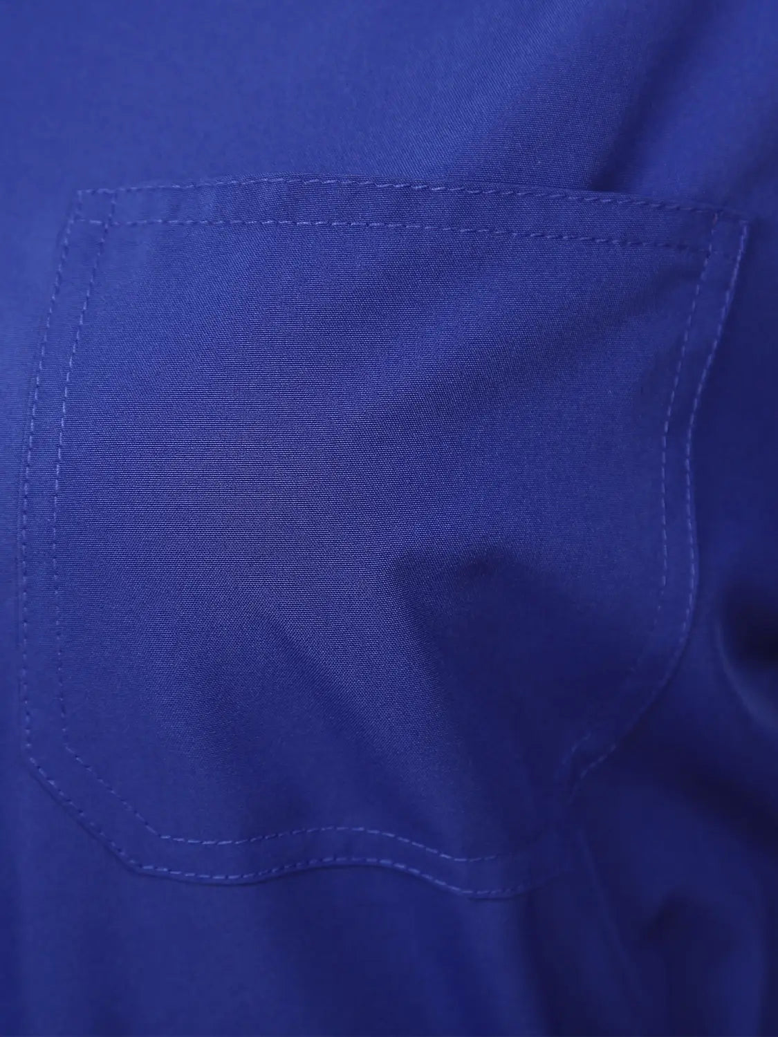 A rich royal blue fabric pocket with neatly stitched edges and a subtle woven texture on a women long sleeve utility jumpsuit.