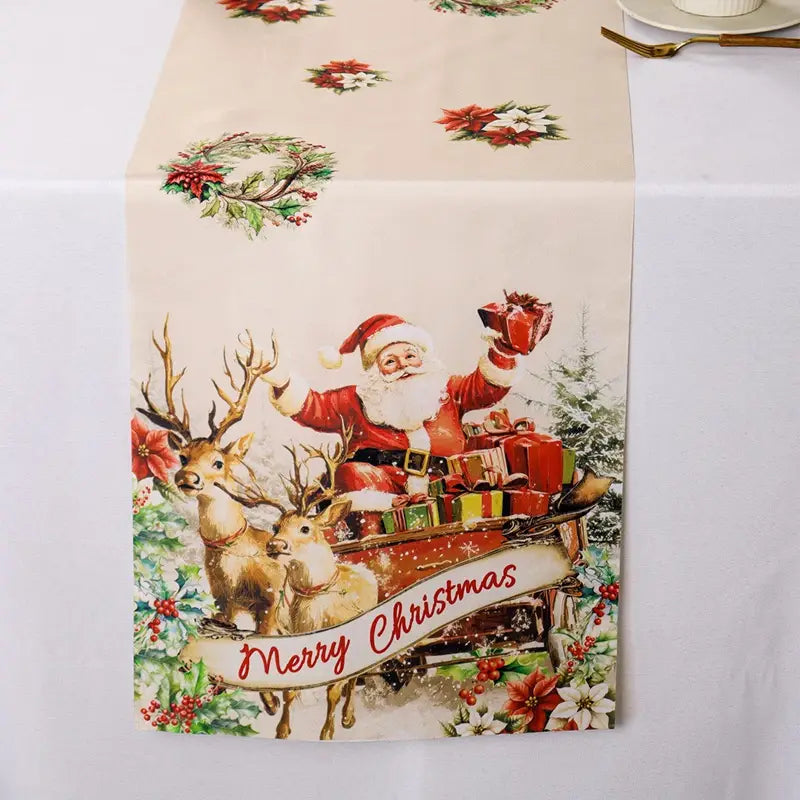 Ein festlicher Tischläufer in Cremefarben mit einer Vintage-Illustration von Santa Claus in seinem roten Anzug, der einen Rentierschlitten reitet, umgeben von Weihnachtssternen und Stechpalmen-Kränzen, mit „Merry Christmas“, in geschriebener Form auf einem Banner, im rustikalen Landhausstil