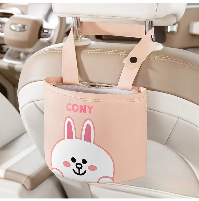 Organizador cilíndrico para reposacabezas de coche de piel sintética color rosa, con un tierno diseño de conejito blanco y marca rosa de cony en el reverso, para almacenamiento del asiento de coche.