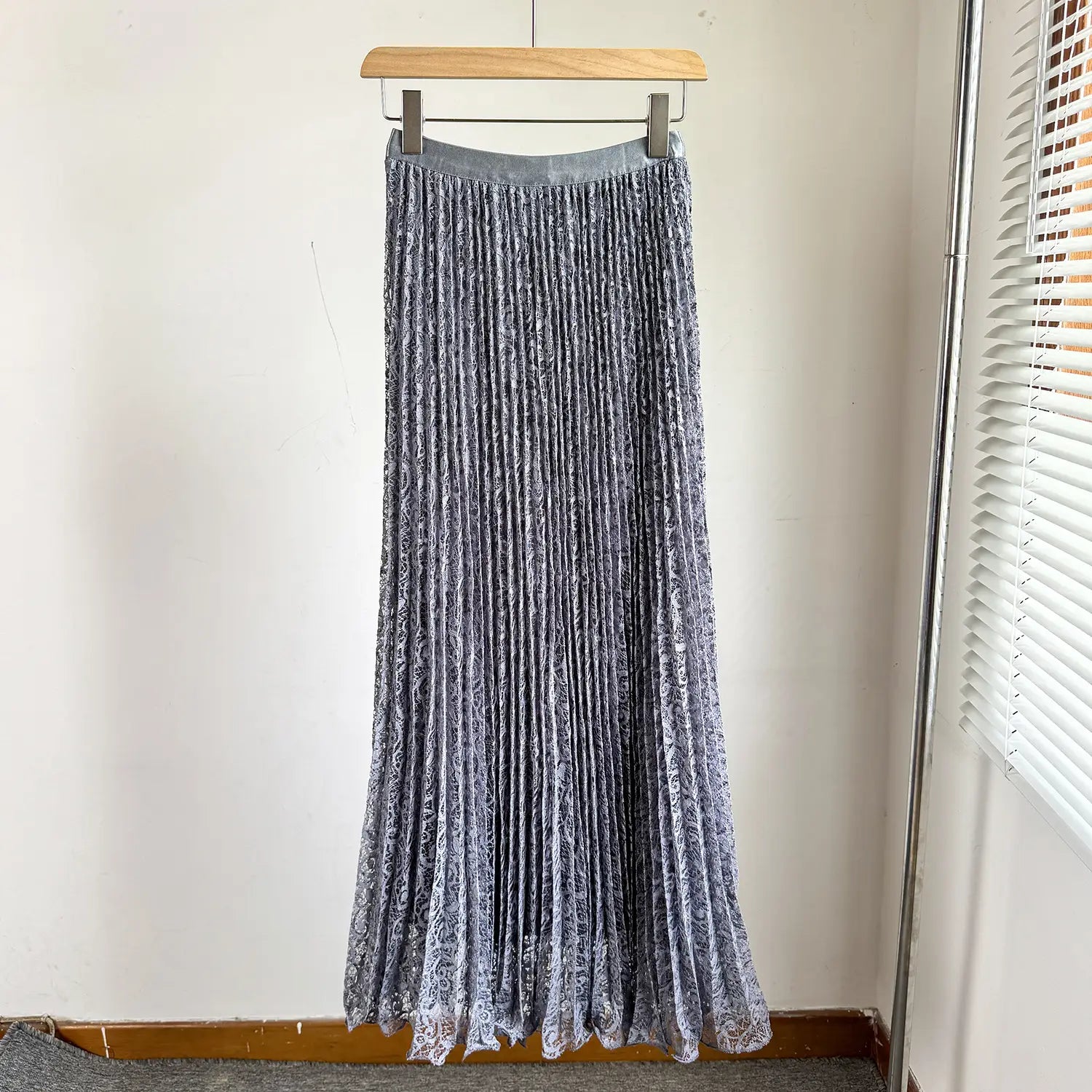 A high waist pleated midi skirt in gray velvet with a subtle pattern and lace trim at the hem suitable for Y2k streetwear.