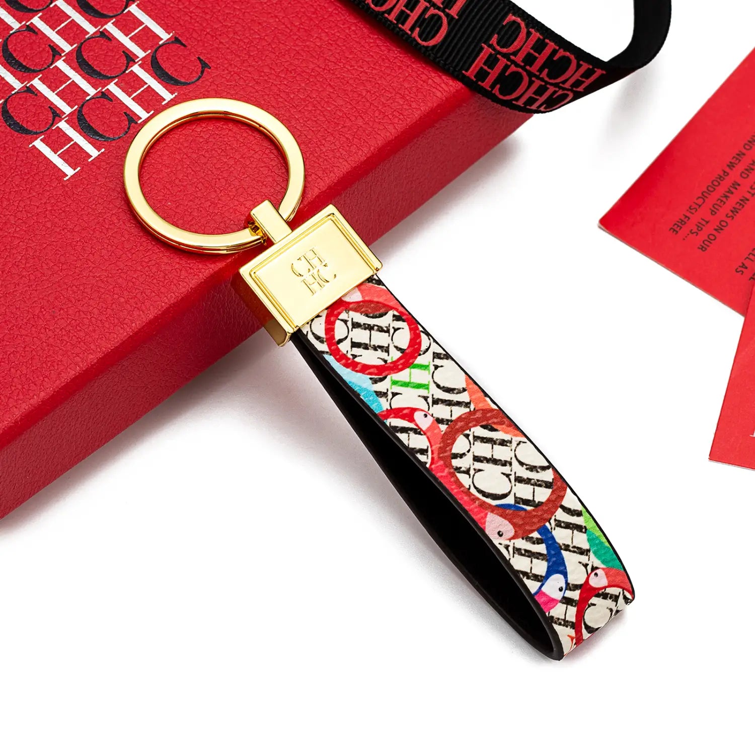 A vibrant multicolored leather logo keychain featuring a repeating chc logo pattern with black edges on a white background designed as a fashion accessory gift.