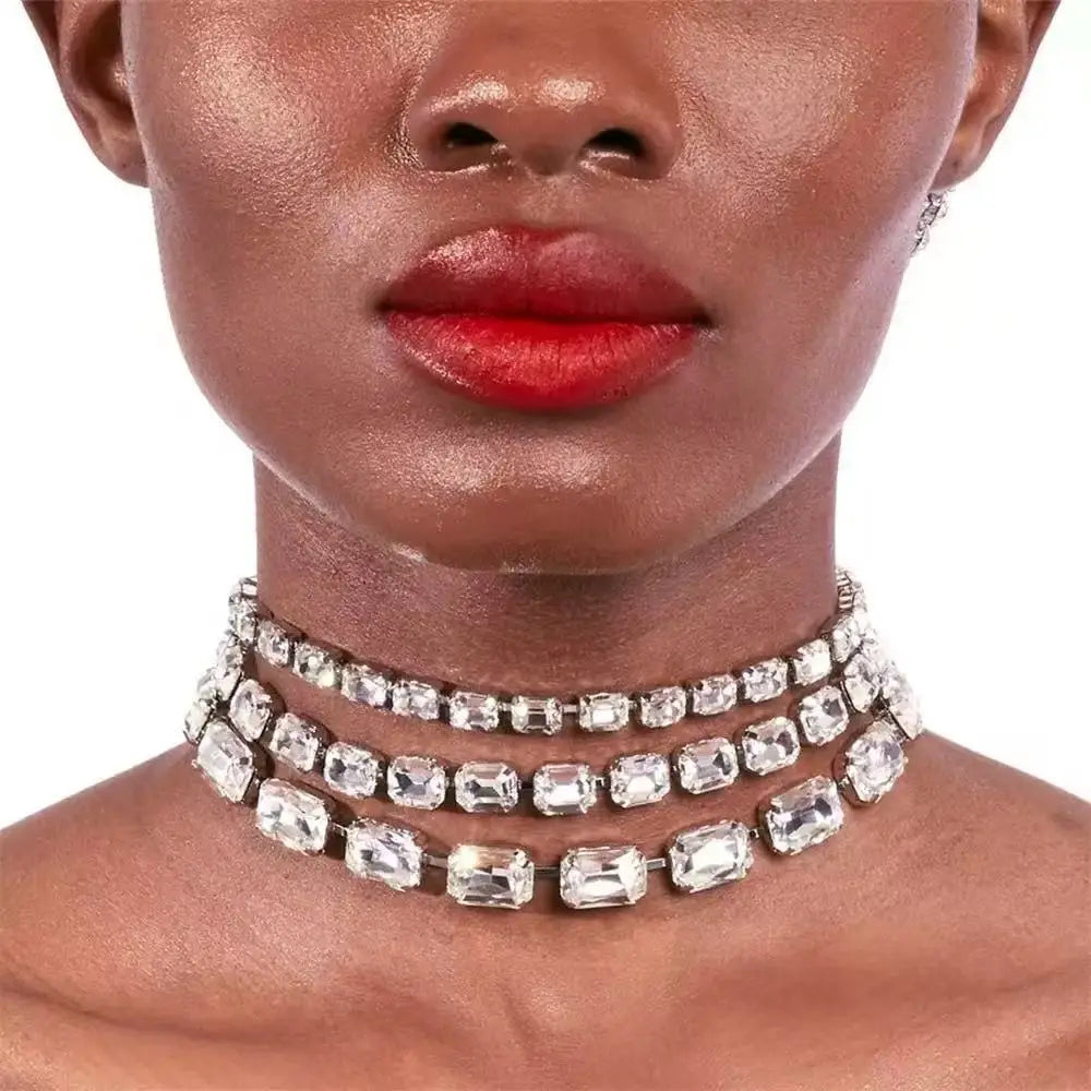 A sparkling multi-strand crystal statement choker necklace for women featuring clear rectangular-cut crystals set in a sleek silver-toned metal frame.