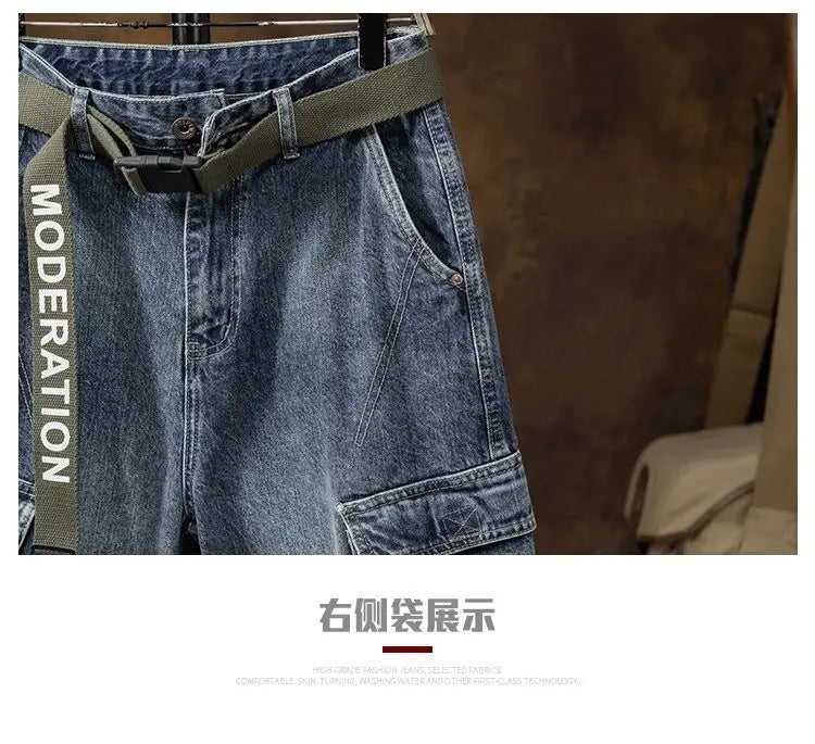 Men denim cargo jeans casual loose pants in blue denim with an olive green belt featuring the word moderation printed vertically along the side.