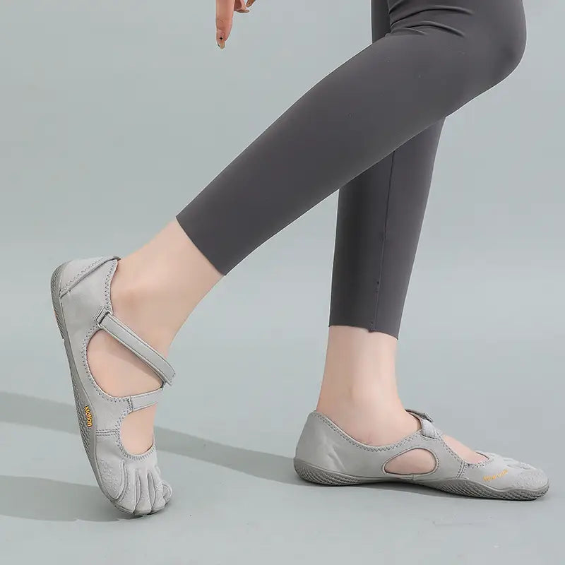 Light gray leather women five toe minimalist barefoot shoes with adjustable straps and a minimalist design.