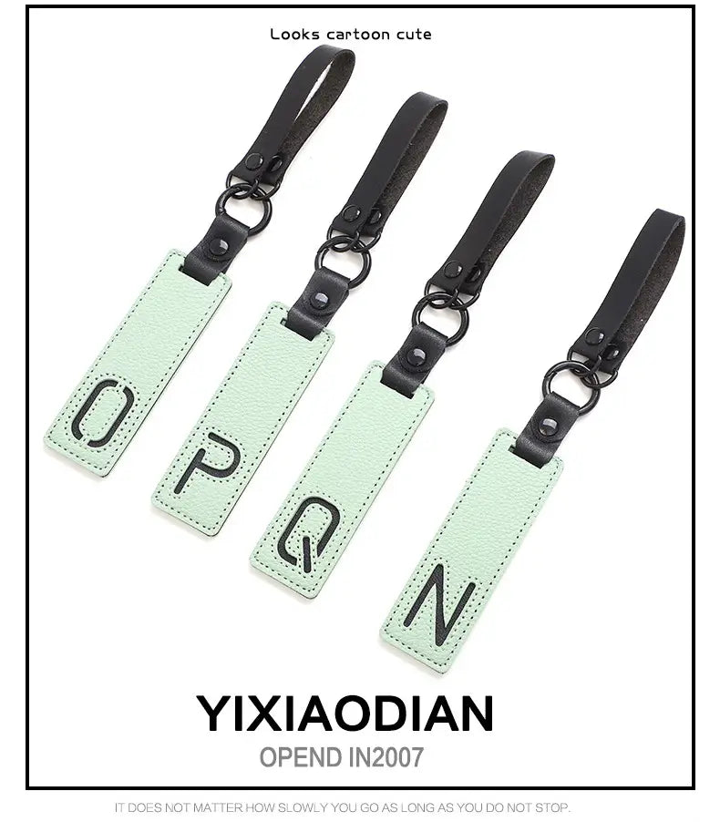 light green rectangular leather luggage tags with black lettering and matching black straps featured as letter keychain leather alphabet pendant party gifts.