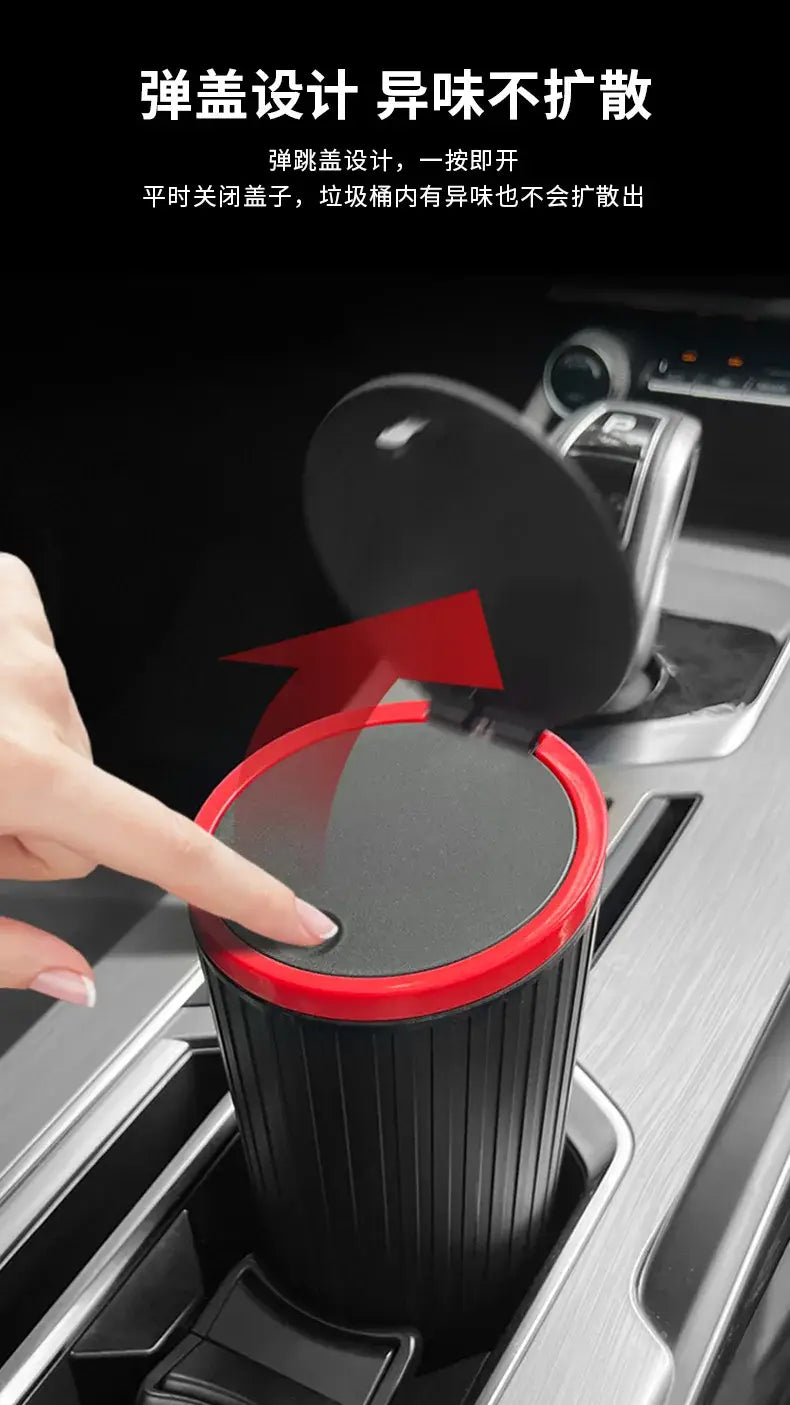 papelera cubo de almacenamiento para basura del automóvil de tipo de prensado cilíndrica negra y roja con tapa de apertura mediante resorte, mostrada desde el frente