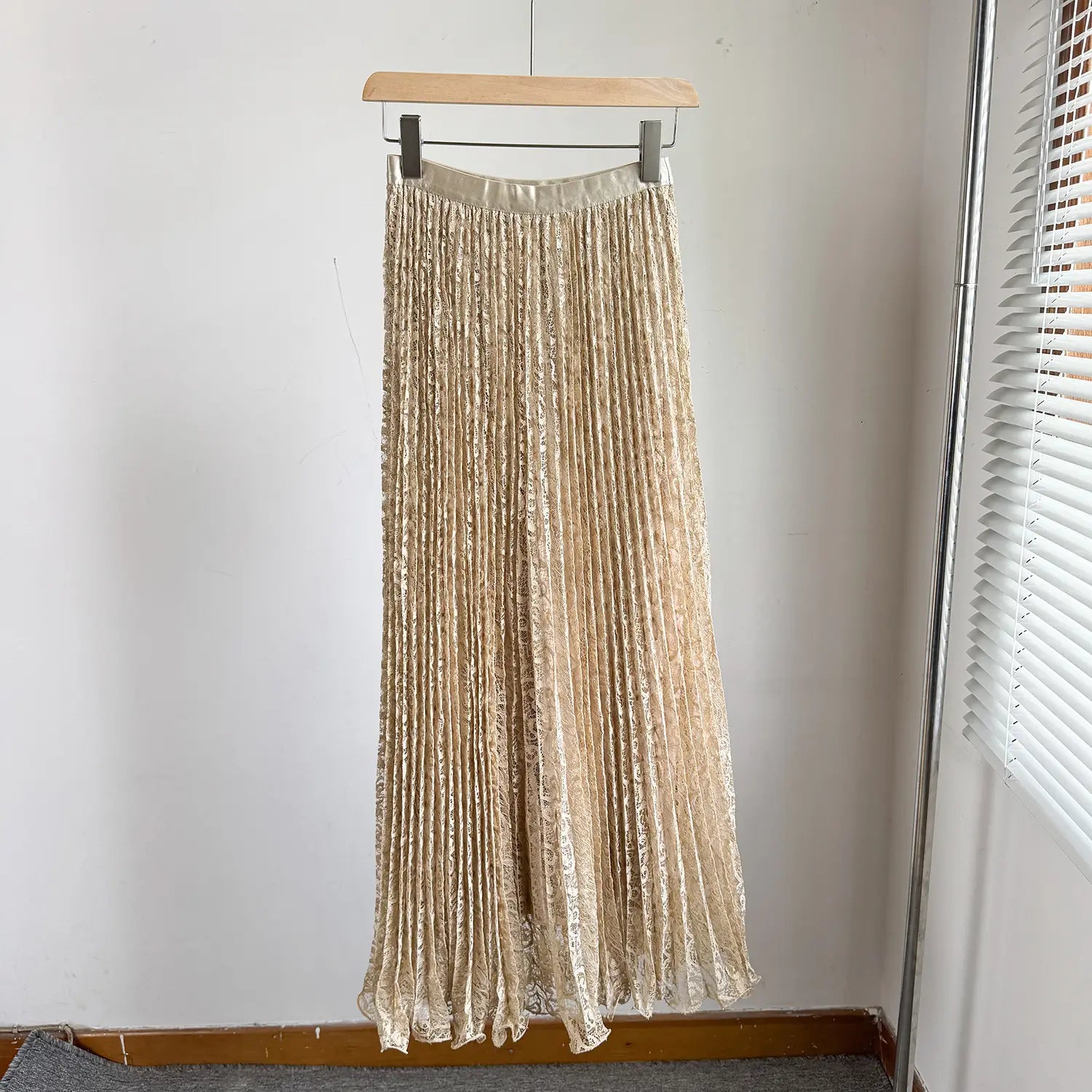 High waist pleated midi skirt in shimmering gold with satin waistband and delicate lace detailing suitable for Y2K streetwear.