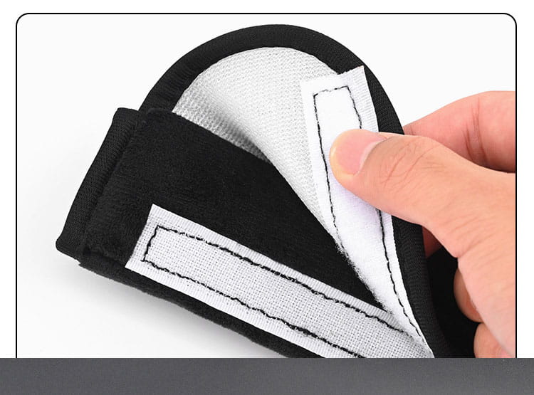 black and white fabric plush seat belt cover with a soft padded interior for car shoulder comfort
