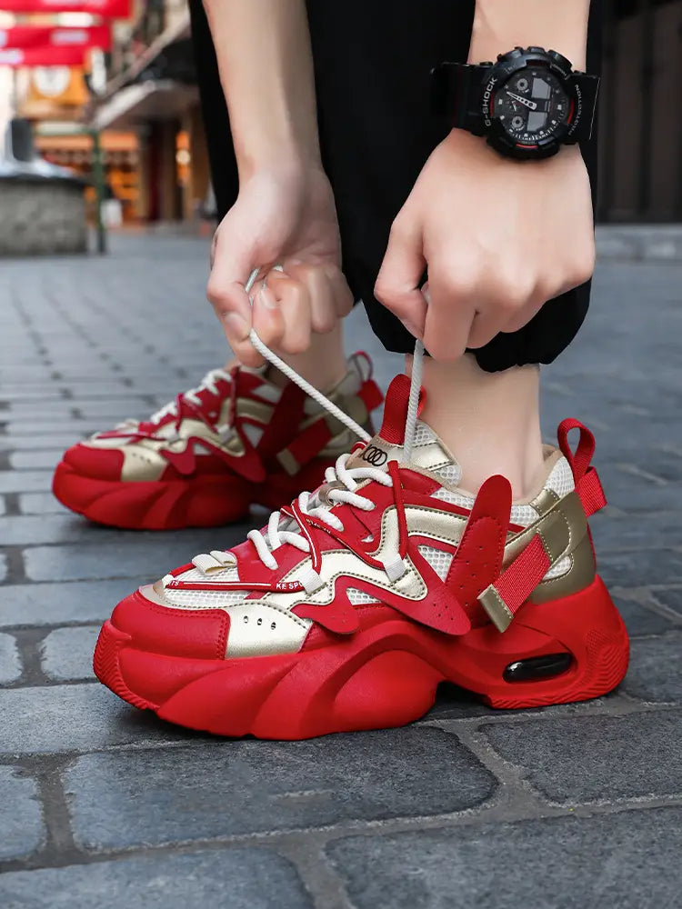 Men chunky air cushion casual sneakers featuring a bold sculpted design in red and gold with visible air cushioning.