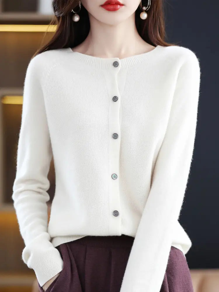 A soft white merino wool cardigan for women with a round neckline and five dark gray buttons down the front.