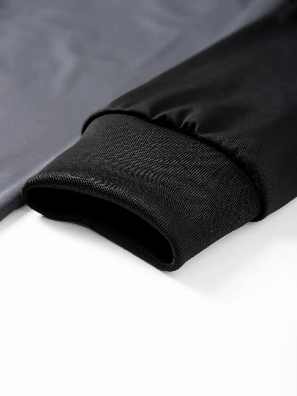 Mens raglan long sleeve casual t-shirt featuring a black ribbed knit cuff on a dark gray jacket sleeve.