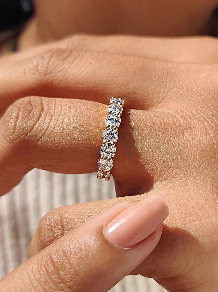 Sterling silver zircon wedding band for women featuring a delicate platinum band with five round-cut diamonds set in a continuous line.