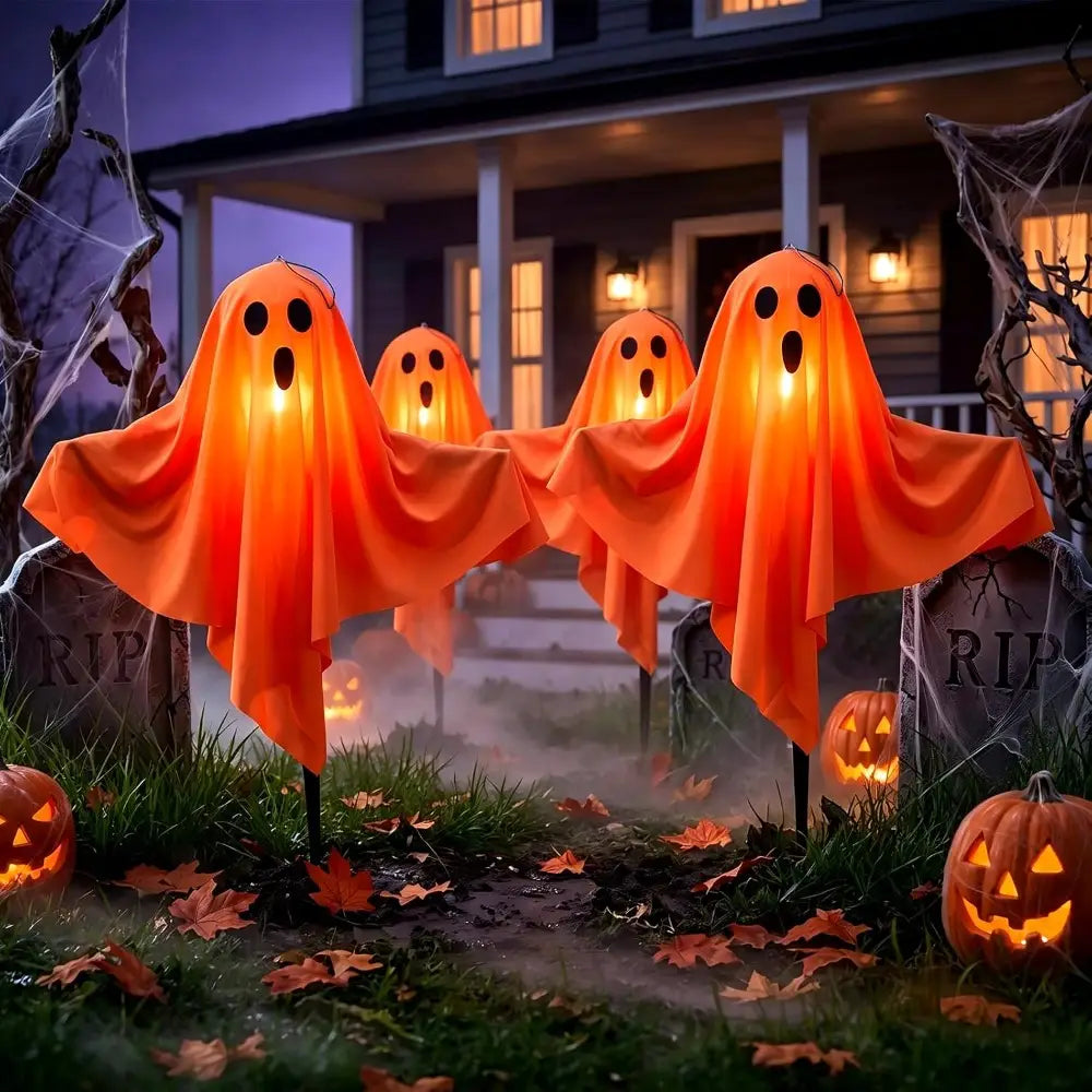 orange glowing halloween ghost pathway lights made of lightweight fabric with black eye and mouth cutouts for outdoor plug in ghost lights decor