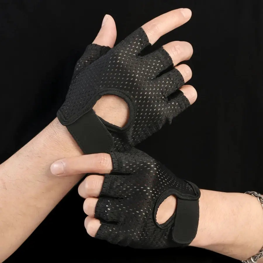 Black mesh fingerless weight lifting gloves with adjustable wrist straps designed for breathable gym exercise fitness use shown from the back side.