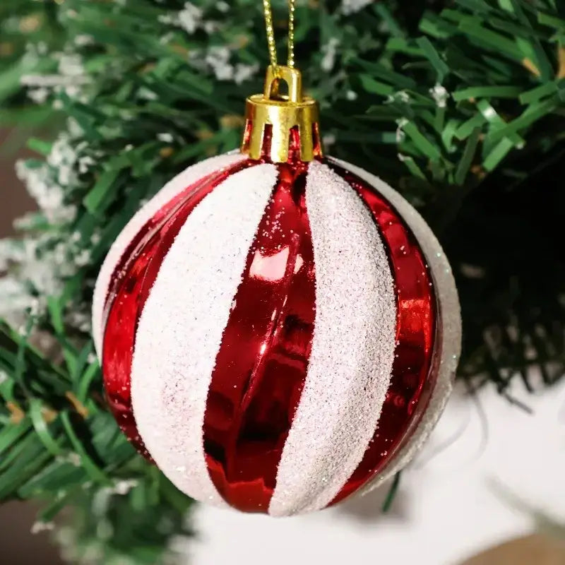 a glossy red and white striped christmas ball ornament with glittery silver stripes and a gold-colored hanging loop from a set of six christmas tree ornaments measuring 6cm