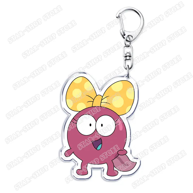 A pink round amphibia anime acrylic keychain featuring a cartoon character with a yellow polka-dot bow and a silver metal clip.