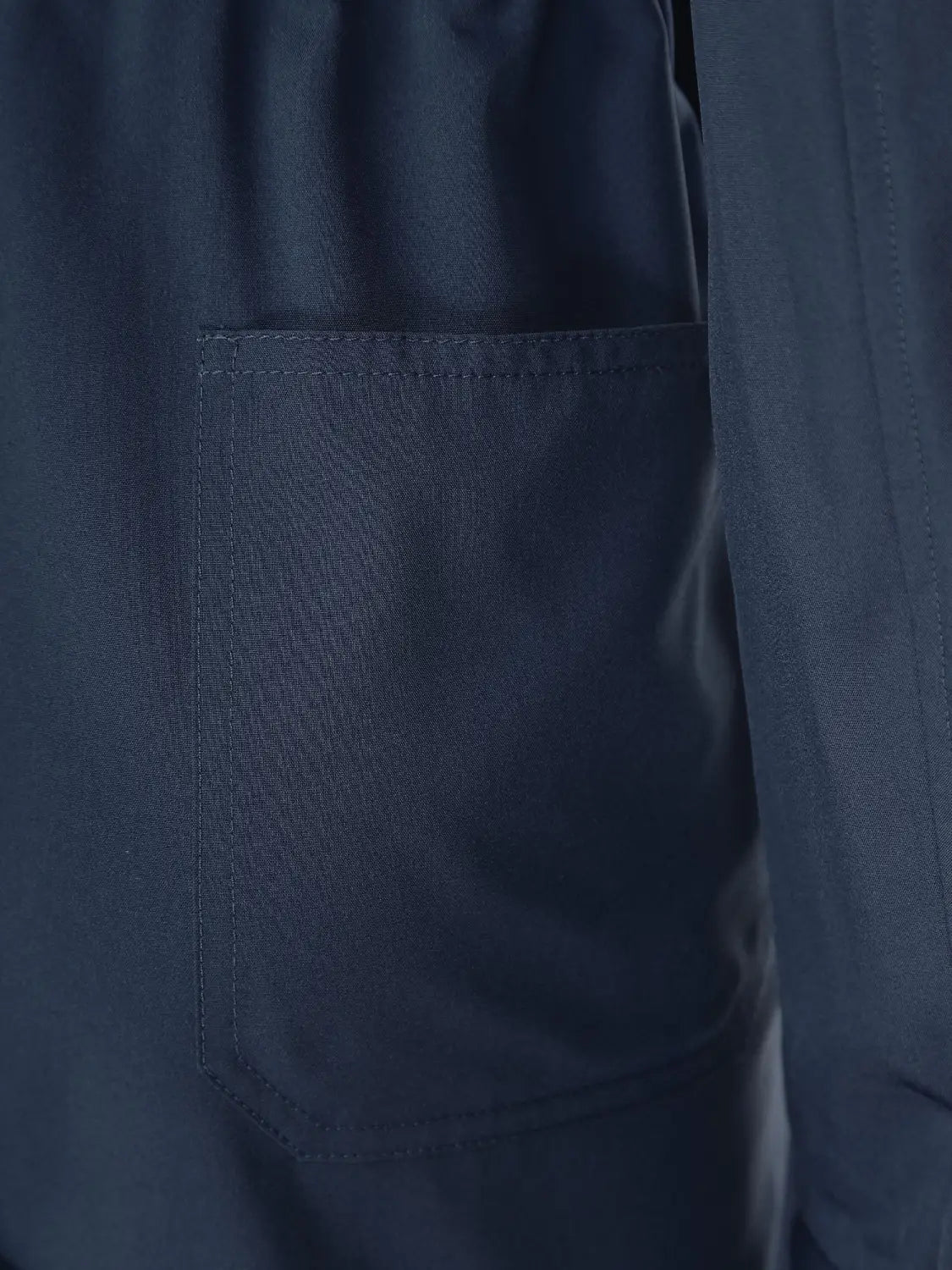 Royal blue long sleeve casual jumpsuit featuring a dark navy fabric pocket with neat stitching and subtle texture.