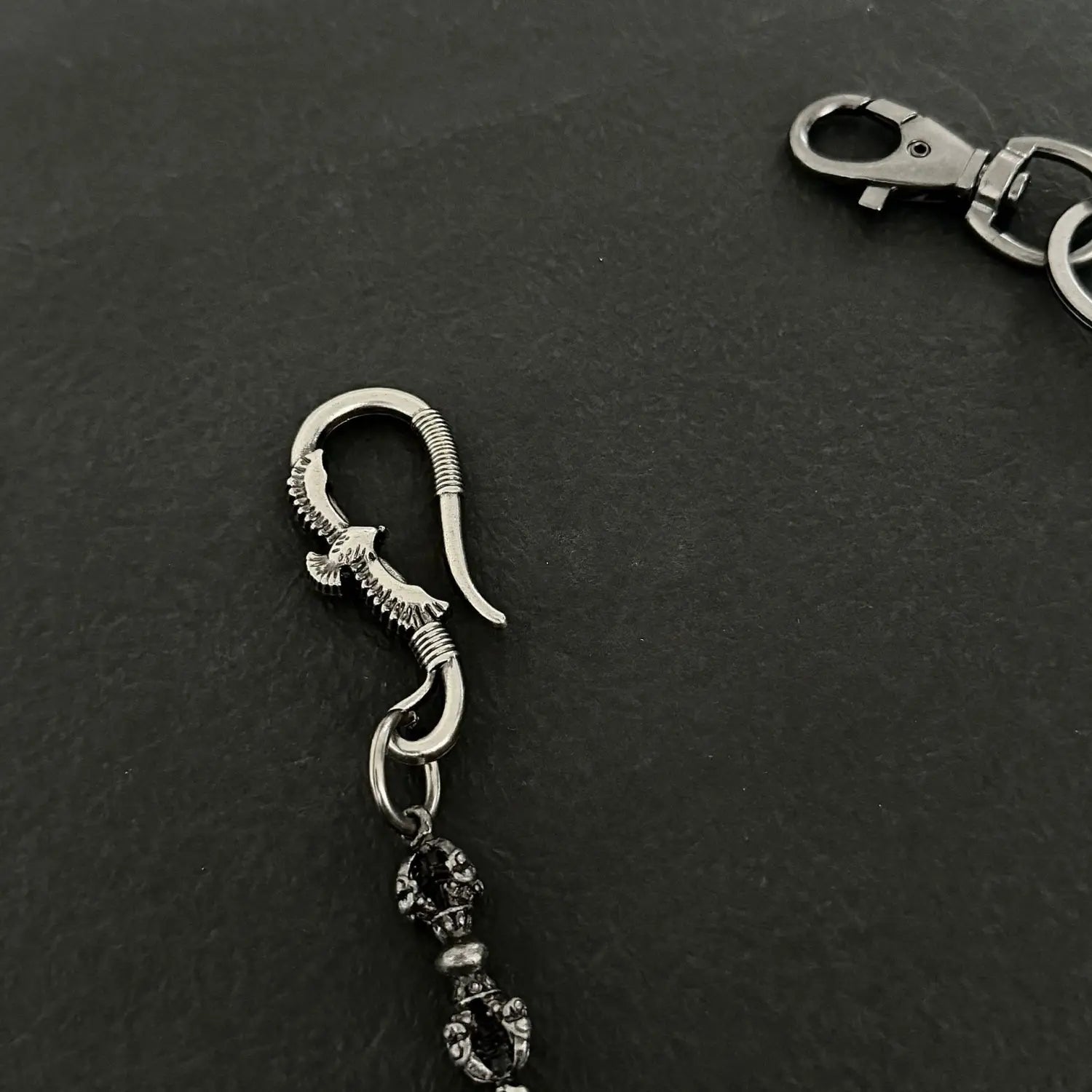 silver eagle-shaped hook charm with black gemstone and intricate metal detailing for men eagle punk trouser chain heavy metal wallet accessory