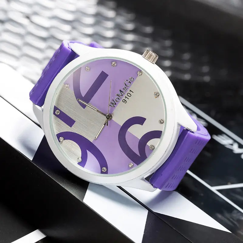 Womage silicone quartz women sports watch with a purple and white analog dial featuring bold purple numerals and crystal markers on a silver-toned face with a silicone strap.