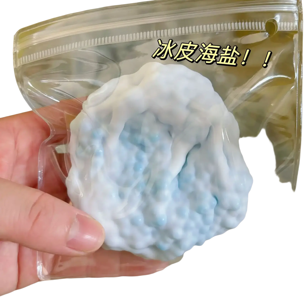 A light blue and white snow skin sea salt squishy toy in a clear bag labeled ice skin sea salt for stress relief