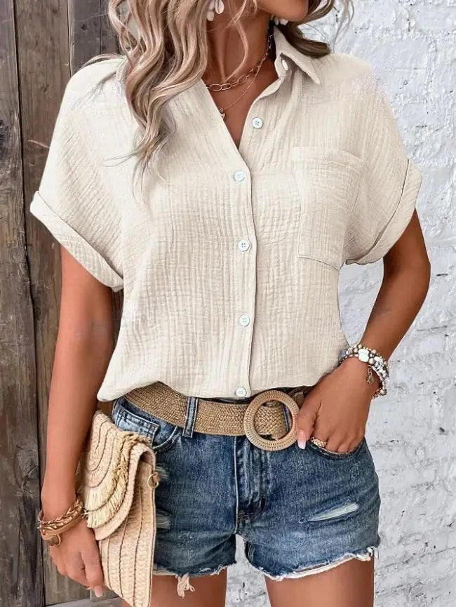 Beige textured cotton button-up shirt for women featuring short rolled sleeves and a chest pocket.