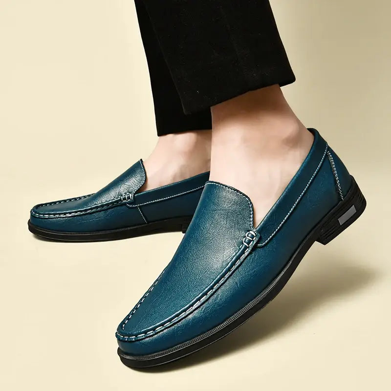 Men genuine leather slip-on dress loafers in teal with white stitching and black rubber sole.
