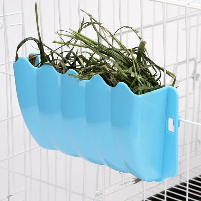 Light blue plastic external rabbit hay feeder with a wavy segmented design for use as a hanging food rack.