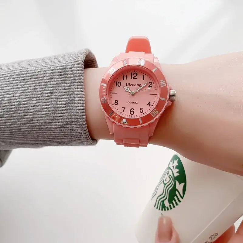Kids silicone quartz watch featuring a pink silicone band and matching pink face with silver-tone hands, bold black numerals, and the brand name uizcango above the 6 o’clock position.