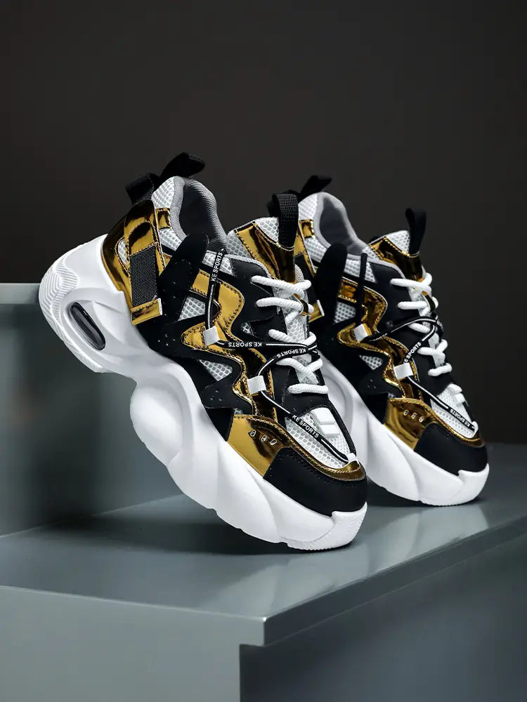 Men chunky air cushion casual sneakers in black and gold with white mesh accents and a thick cushioned sole