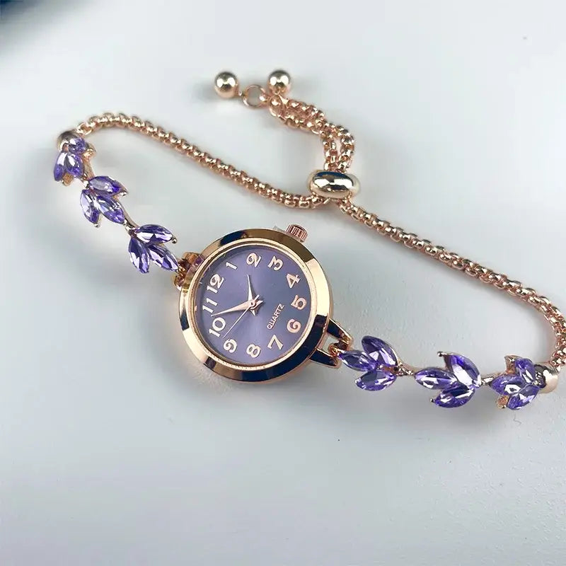 A delicate rose gold women rhinestone quartz watch with a lavender dial and purple gemstone leaf accents on the crystal leaf bracelet chain.