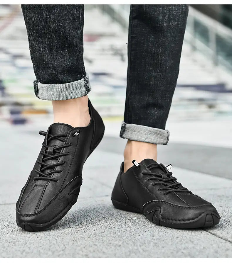 Men high top leather casual sneakers in black with lace-up design and subtle stitching details for a sleek modern look.